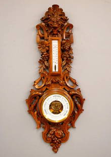 Carved French Barometer: A late 19th century French Barometer by "J. Mahier au Havre". Upper Centigrade thermometer with porcelain dial and lower Aneroid barometer with circular porcelain dial. Hand carved Oak case with Lion'