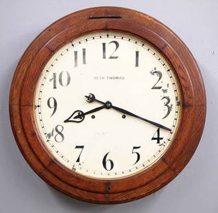 Seth Thomas Arcade Gallery Clock: A late 19th century Seth Thomas "Arcade" model Gallery clock. 30-day dual spring time only movement with 18" painted metal dial and Arabic numerals. Molded Oak case with lift door. Some finish wear, d
