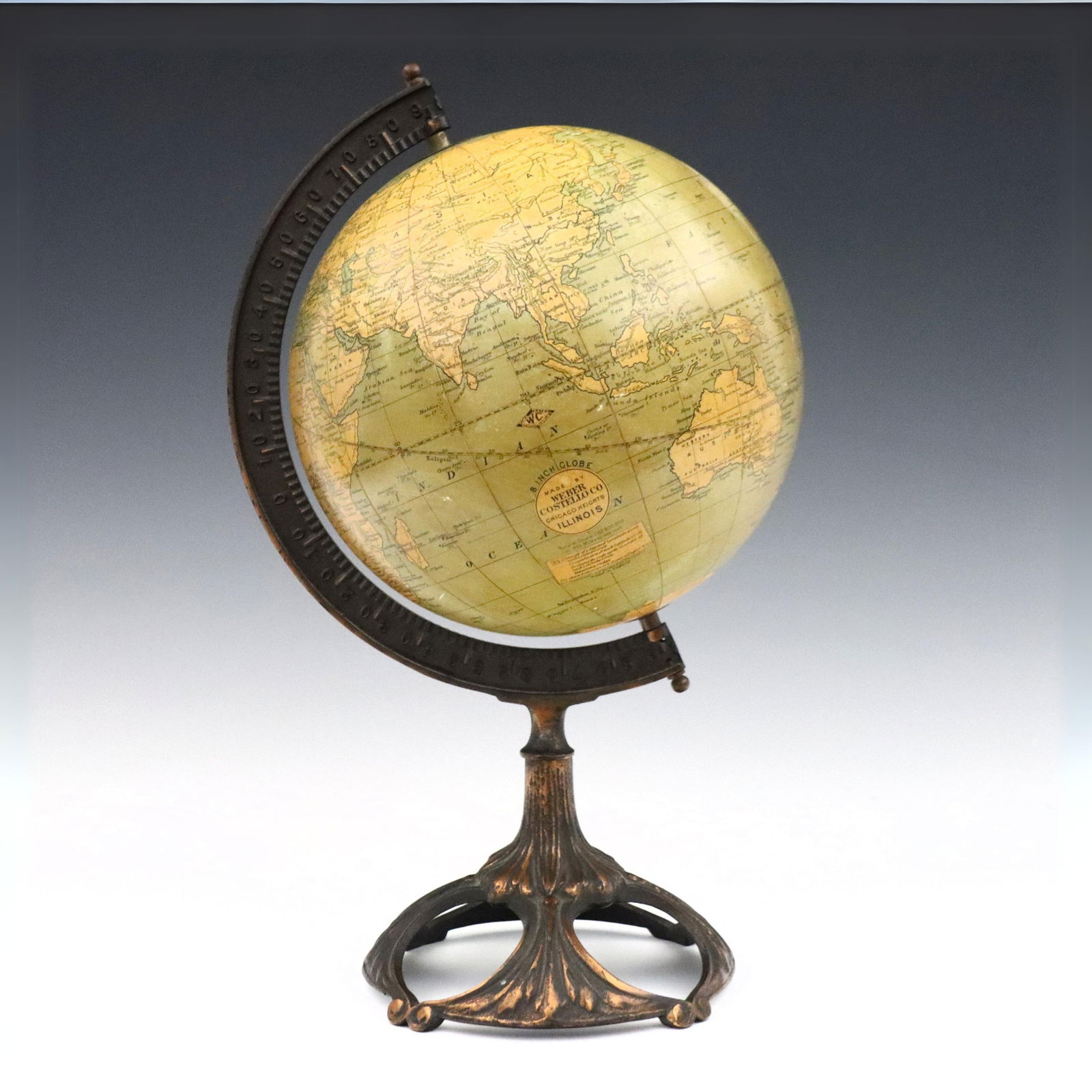 Weber Costello Globe: An early 20th century globe by Weber Costello Co., Chicago Heights. On a Cast Iron stand with Copper plated detail. Some wear to globe. 6 1/2" globe, 14 1/2" high overall. ESTIMATE $200-300