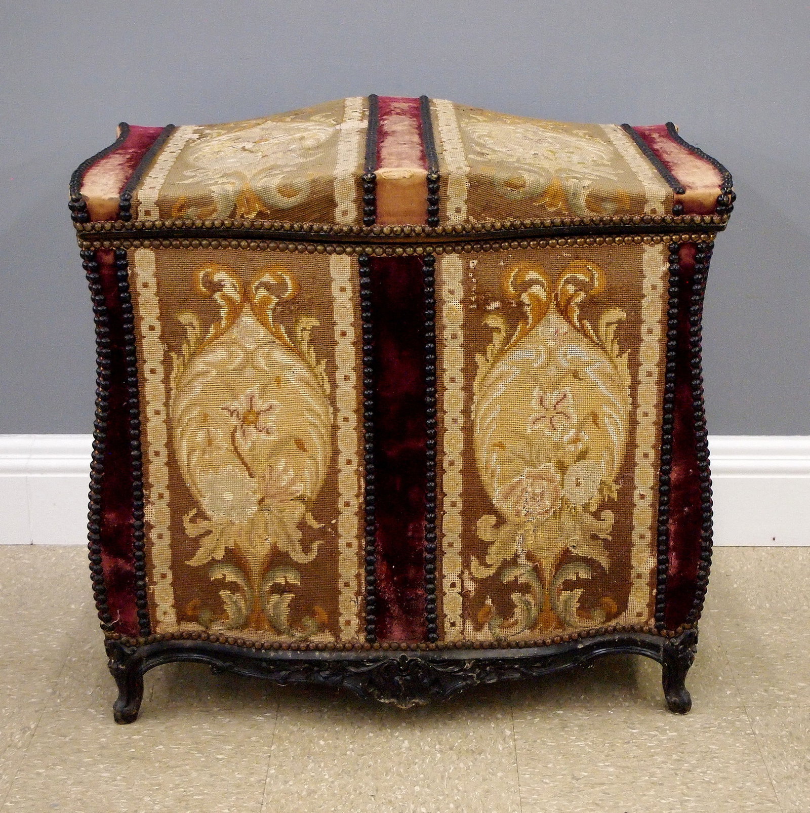 Italian Upholstered Blanket Box: An 18th century Italian blanket storage box. Softwood construction with a decorative tapestry and velvet upholstered exterior with Brass tack trim, features a shaped lift top and bombe body on a shape