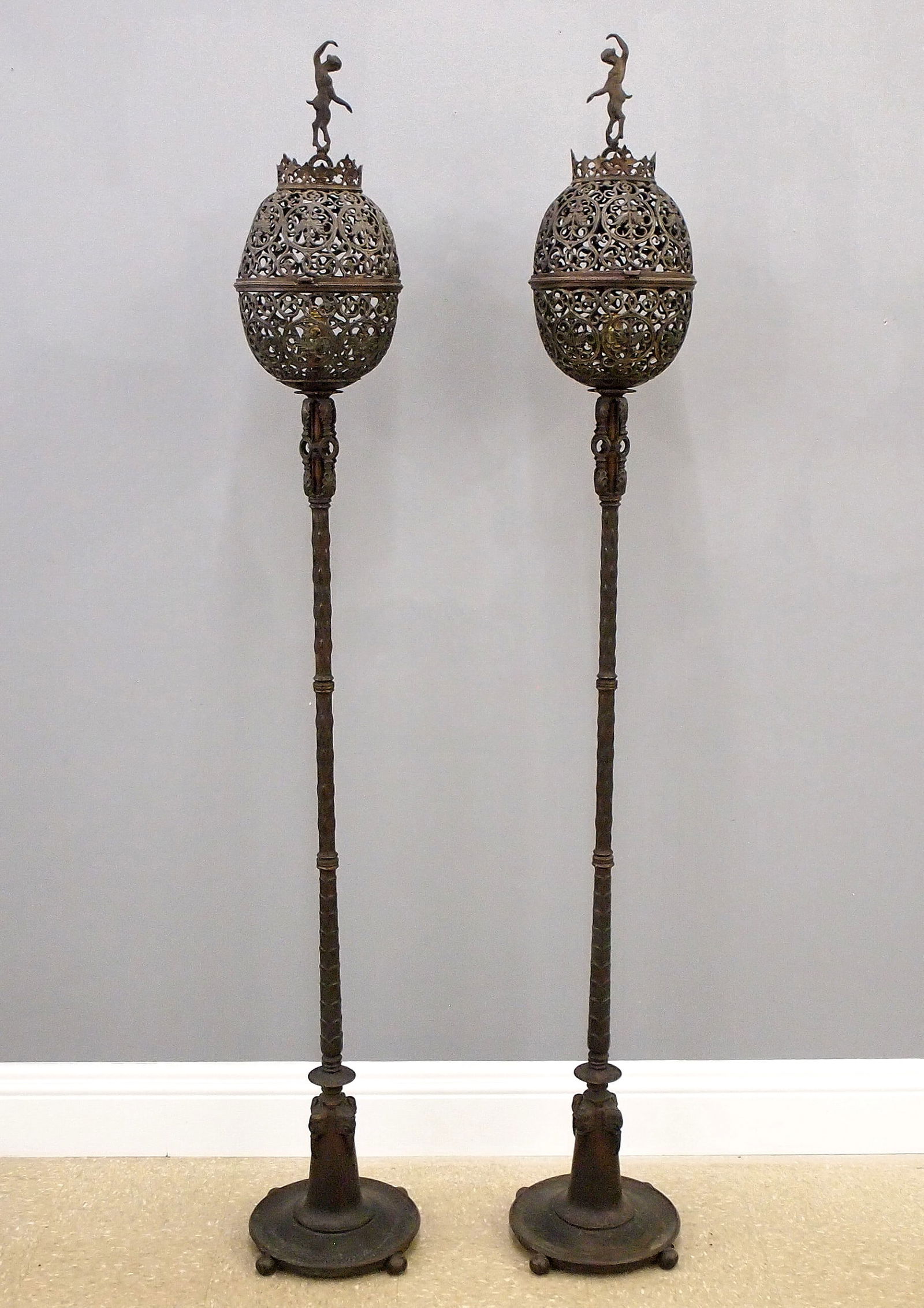Pr Oscar Bach Torchieres: A pair of early 20th century Oscar Bach torchieres, c. 1925. Patinated Brass, Iron and Lead construction with dancing Bacchante finials over reticulated upper sections, on slender stems with foliate d