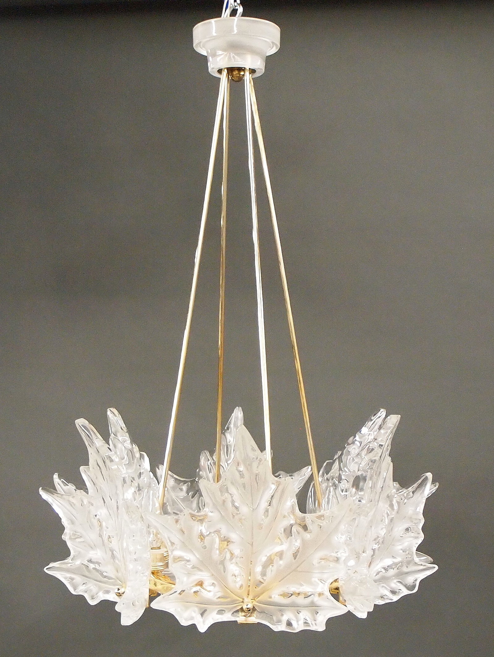Lalique Champs Elysees Crystal Chandelier: A 1960's Lalique "Champs Elysees" Crystal chandelier. Elaborate six light chandelier with molded Sycamore leaf design and frosted detail in a hexagonal Gilded Brass frame with four suspension rods and