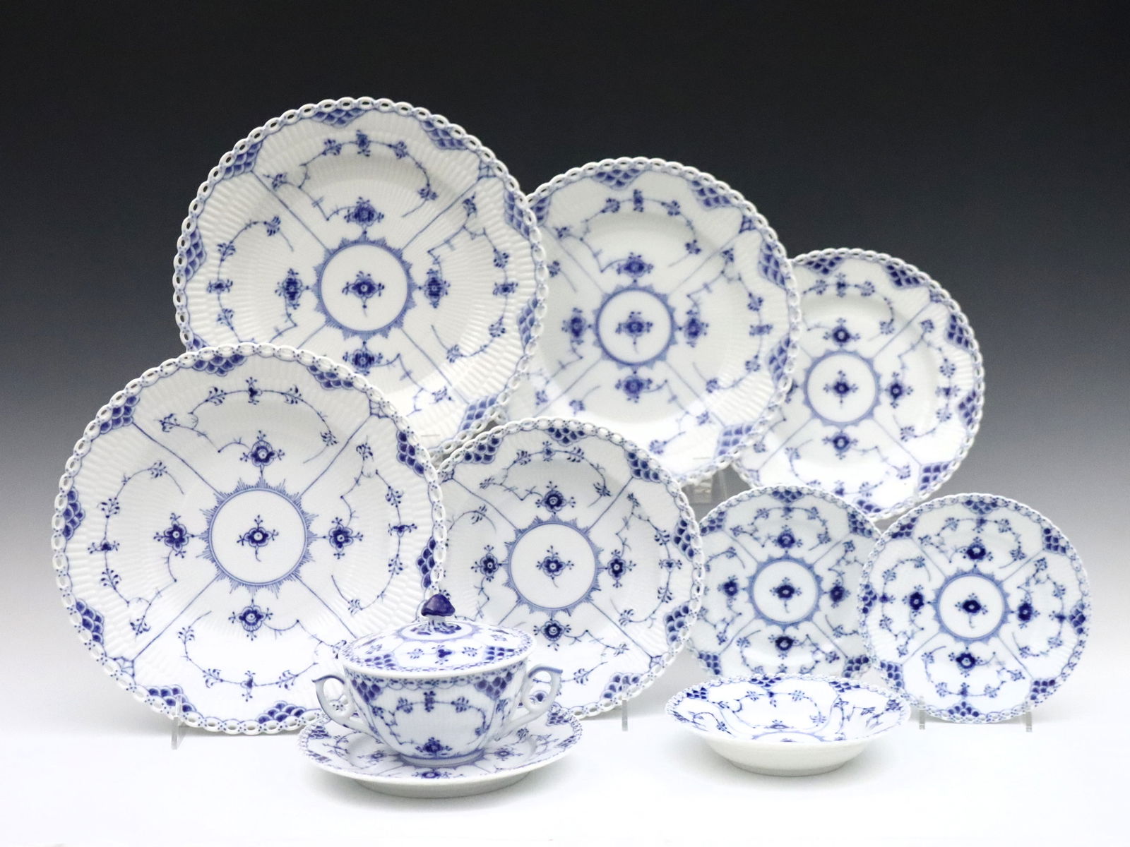 72 pc Royal Copenhagen Tableware: Seventy-two pieces of 20th century Royal Copenhagen "Blue Flued Full Lace" porcelain tableware. Includes 8 x 10" dinner plates, 8 x 10" shallow bowls, 8 x 9" salad plates, 8 x 8" bowls, 8 x 7 3/4 brea