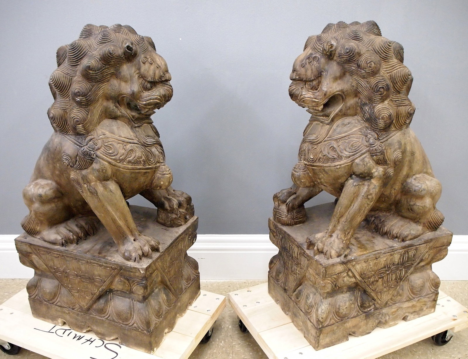 Pr Chinese Marble Foo Dogs: A pair of mid 20th century Chinese Marble Foo Dogs. Seated imperial guardian figures with patinated finish. Some surface wear. Each 31 1/2" high. ESTIMATE $1,000-2,000