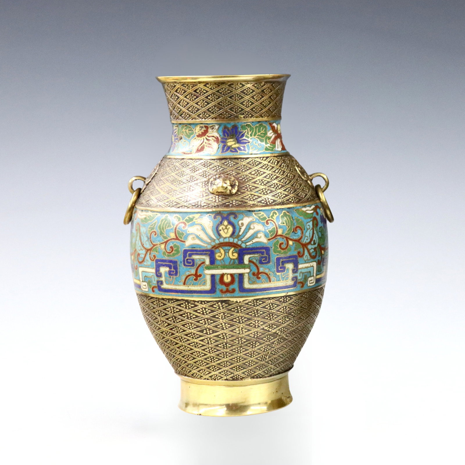 Japanese Bronze Vase: A 20th century Japanese Bronze vase. Baluster form with loose ring handles, multi-color champleve bands and engraved floral decoration. Some wear, repair at foot. 12" high. ESTIMATE $100-150