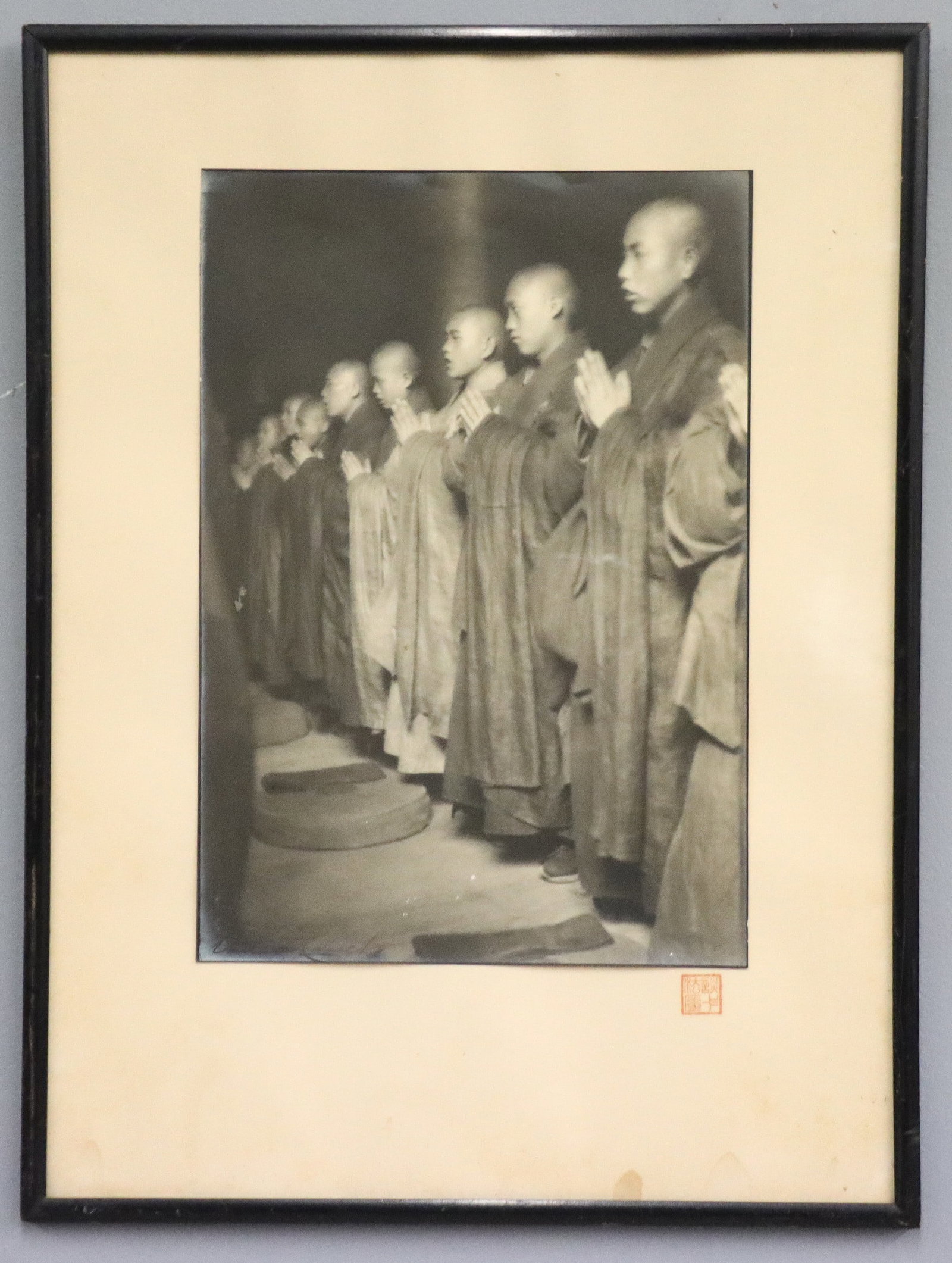 A. De Carvalho Photograph of Buddhist Monks: Arthur De Carvalho, French, 19th/20th century. A 1930's gelatin silver photograph on paper. Depicts a line of praying Buddhist monks in Shanghai, China. Signed "Arthur de Carvalho" lower left, seal wi