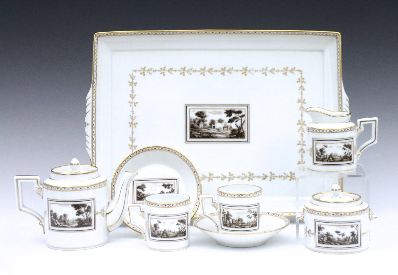 R. Ginori Pittoria Porcelain Tea Set: A 20th century Richard Ginori "Pittoria/Fiesole" pattern porcelain 'tete a tete' demitasse tea set. Includes a tea pot, two cups and saucers, creamer, covered sugar and serving tray. Printed "Richard 
