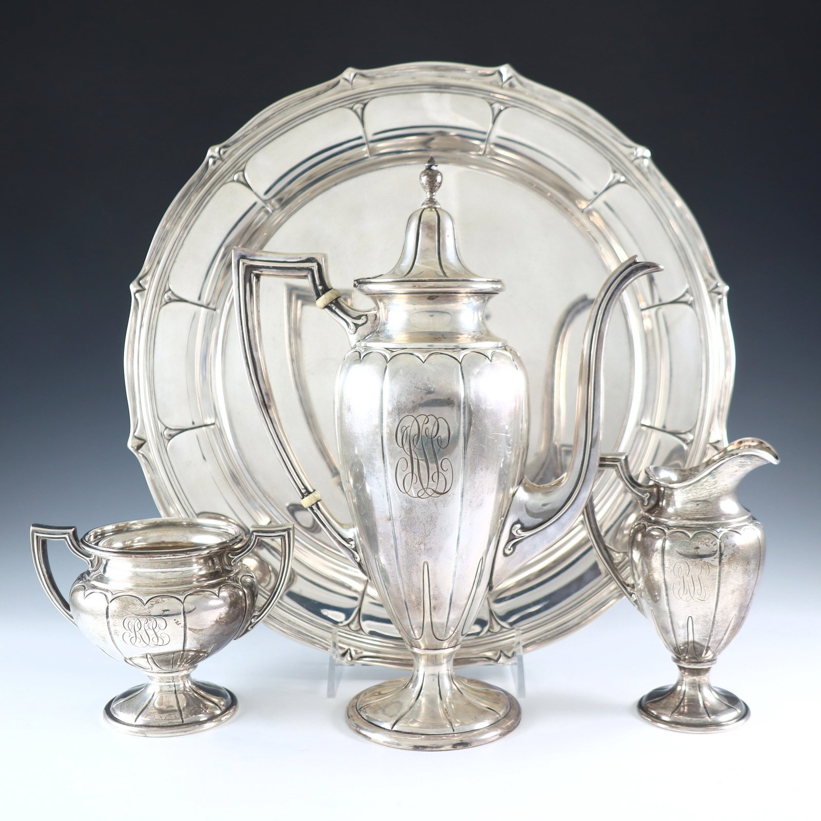Dominick & Haff Sterling Coffee Set: A turn of the century Dominick & Haff Sterling Silver coffee set retailed by J.E. Caldwell. Includes a 10 1/2" coffee pot, 5 1/4" creamer, 3 3/4" sugar, and 12 1/2" serving tray. Each impressed "Sterl