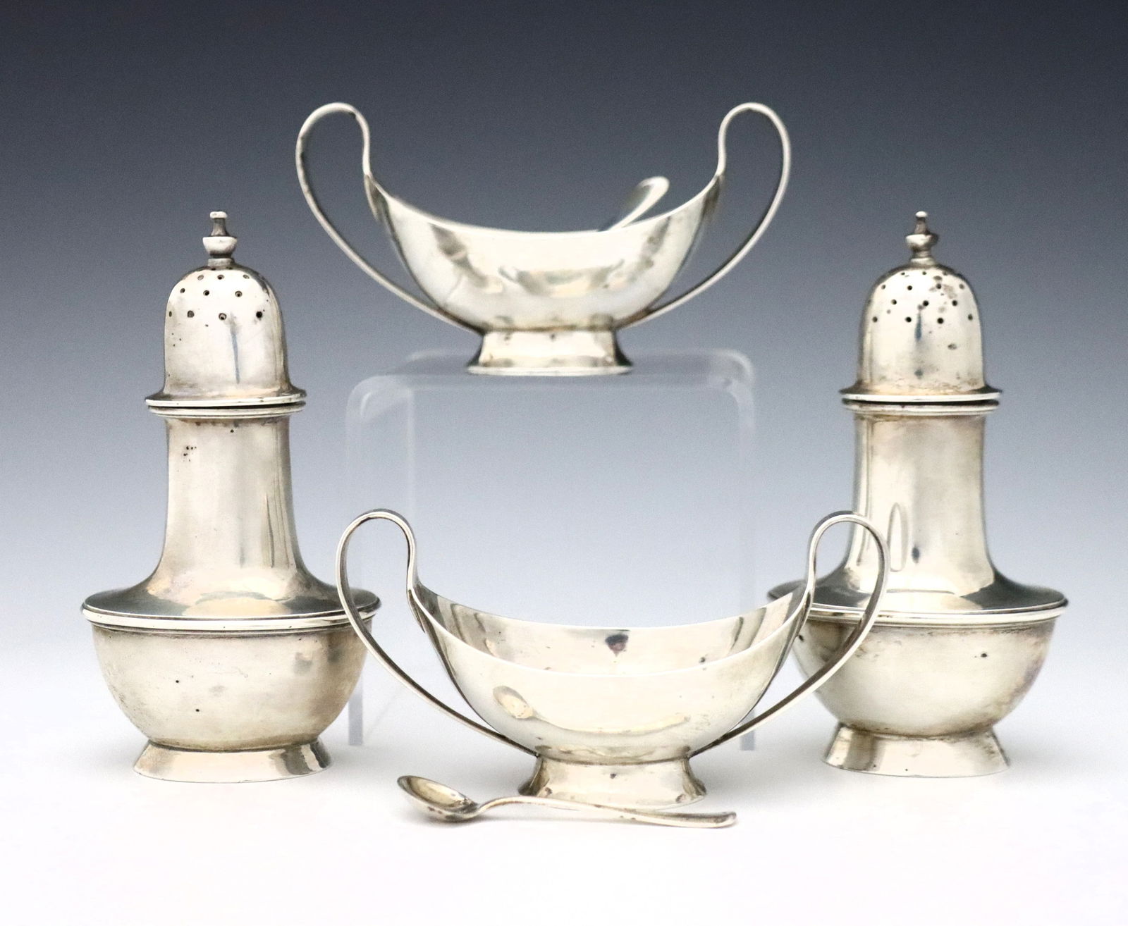 2 Sets A. Stone Sterling Salts: Two sets of early 20th century American Sterling Silver salts by Arthur Stone. Includes a pair of open salt cellars and a pair of salt and pepper shakers. Each impressed "A. Stone" Sterling. 9.78 troy