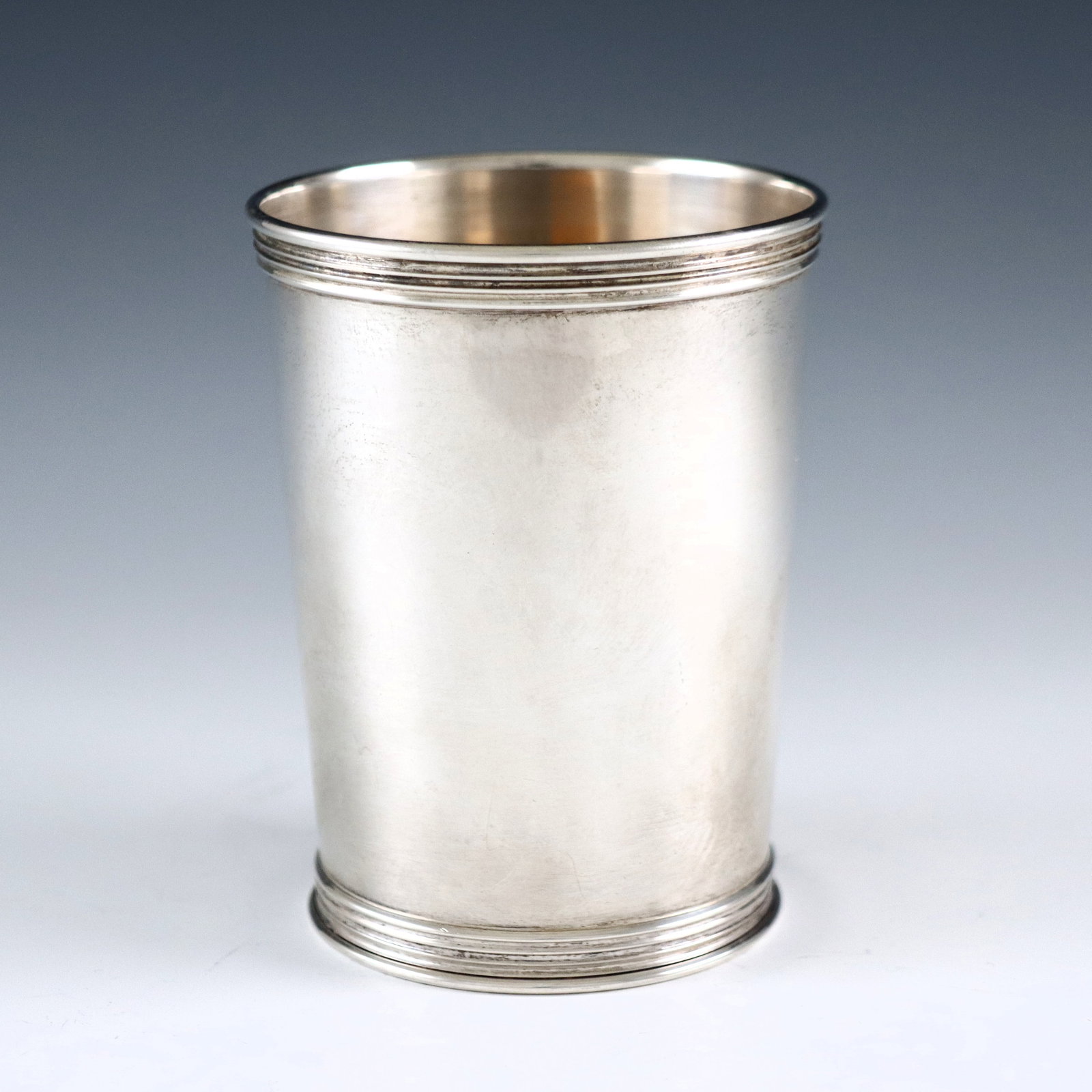 Trees Sterling Julep Cup: A mid 20th century American Sterling Silver julep cup by Benjamin Trees of Lexington, Kentucky, c. 1940. Simple tapered form with reeded rim. Impressed with "Trees" maker's mark and "Sterling". 4.32 t