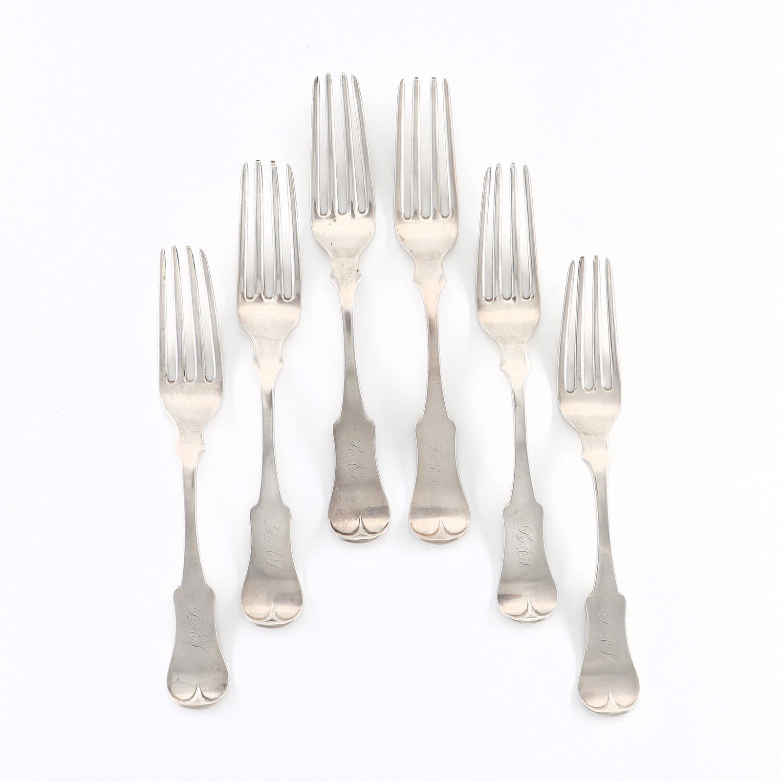6 Kent Coin Silver Forks: Six early 19th century American Coin Silver forks by Luke Kent. Impressed "L. Kent". 9.50 troy ozs total. Some surface wear, monogrammed. 7 3/4" long. ESTIMATE $100-200