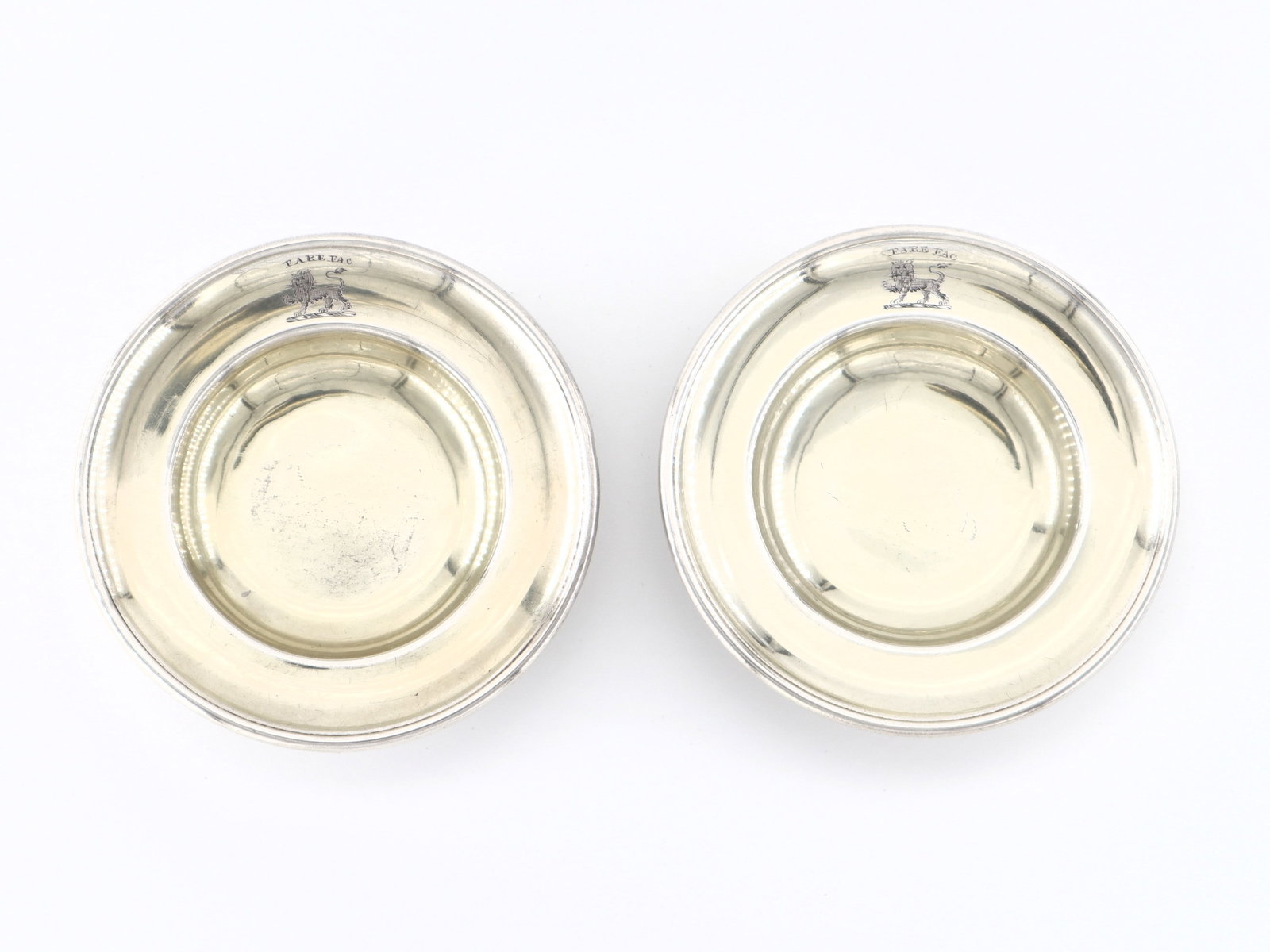 2 Kirby George III Sterling Almond Dishes: Two late 18th century British George III Period Sterling Silver almond dishes by Samuel Kirby & Co., c. 1799. Small circular dishes with gold wash interiors and etched "Fare Fac" (Speak, Do) motto wit
