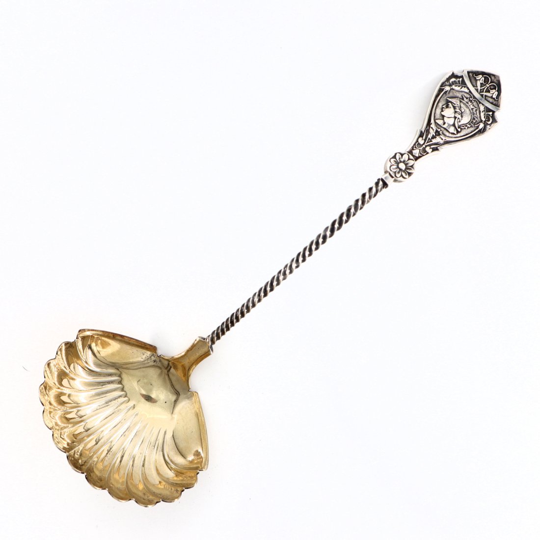 W & H Coin Medallion Ladle: A late 19th century American Coin Silver ladle by Wood & Hughes. Medallion pattern with shell form ladle, gold washed interior and twisted handle. Impressed "W & H" maker's mark. 5.76 troy ozs total.