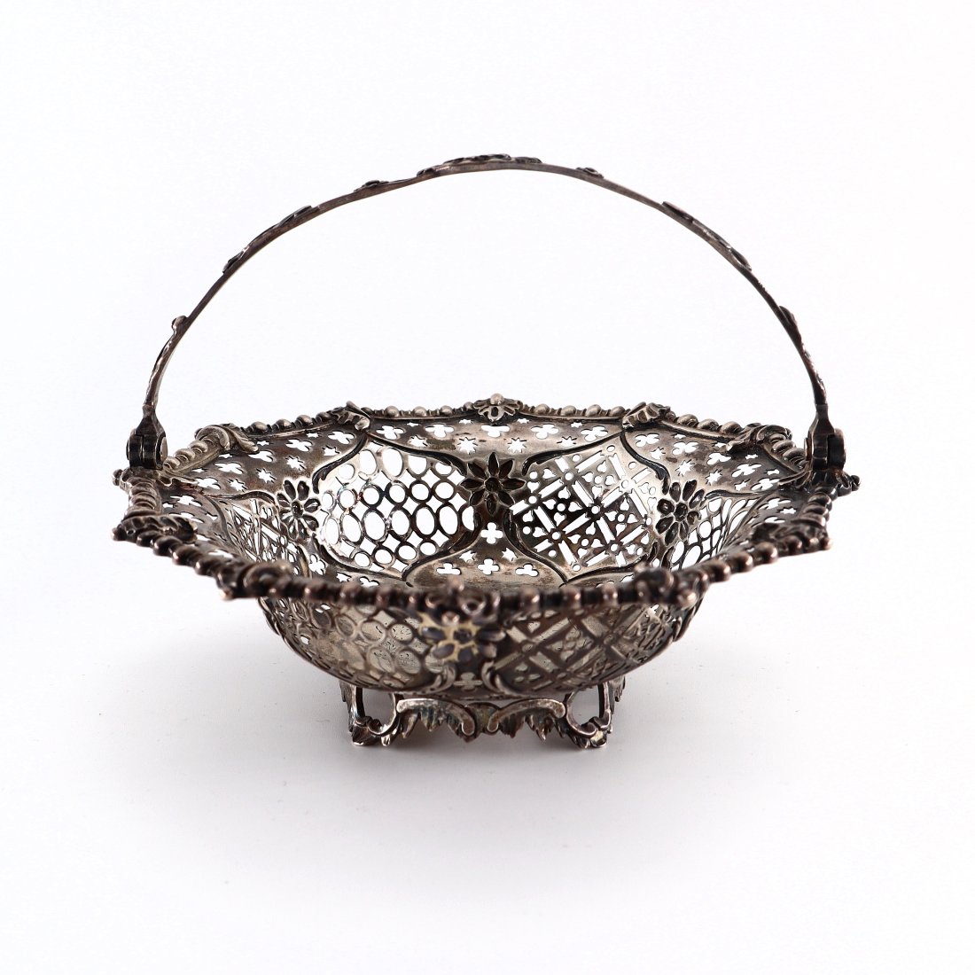 T. Pitts George III Sterling Basket: A late 18th century British George III Period Sterling Silver epergne basket by Thomas Pitts, c. 1770. Articulated handled basket with alternating pierced panels of quatrefoil and star designs within 