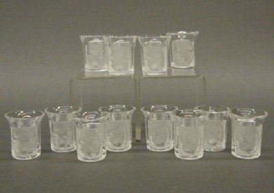 12 Lalique cordials: Twelve 20th century Lalique "Enfants" cordials with frosted detail. Incised signatures. Slight wear. Each 1 1/2" high. ESTIMATE $200-400