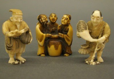 3 Ivory Netsukes: Three 20th century Japanese Carved Ivory Netsukes with inked detail. Depicting two fishermen and a trio of gentleman. Incised signatures. Wear and minor damage. Up to 2" high. ESTIMATE $200-300