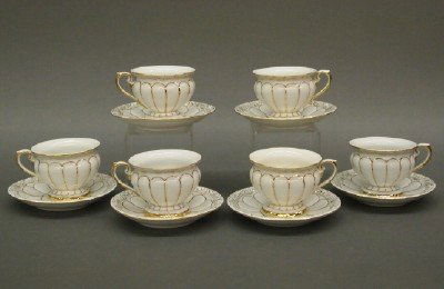 6 Meissen tea cups: Six late 19th century Meissen porcelain teacups and saucers. Molded bodies with paneled design and Fine Gilded detail. Blue underglaze and incised marks. Minor wear. Up to 2 1/2" high. ESTIMATE $100-1