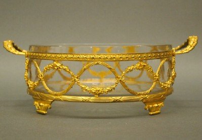Dore Bronze serving dish: A 20th century French Dore Bronze serving dish with ribbon and swag design and cut glass insert. Slight wear. 11 1/2" long. ESTIMATE $100-200