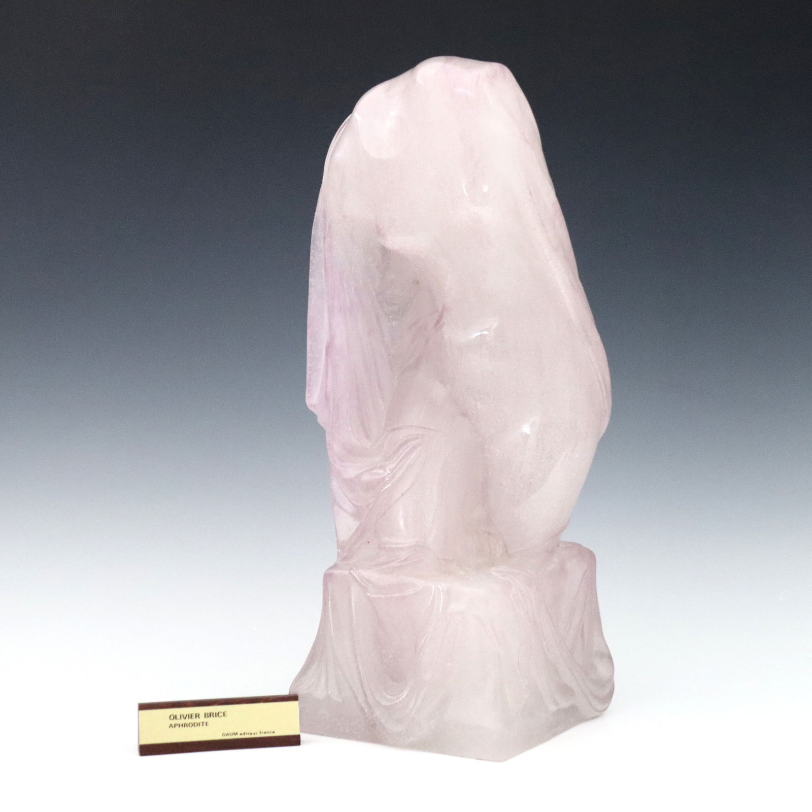 Daum Brice Patte de Verre Sculpture: A 1970's Daum Pate de Verre sculpture designed by Oliver Brice, titled "Aphrodite". Three quarter depiction of a nude Aphrodite with draped cloth in tones of Lavender. Cast "O. Brice" and "Daum France