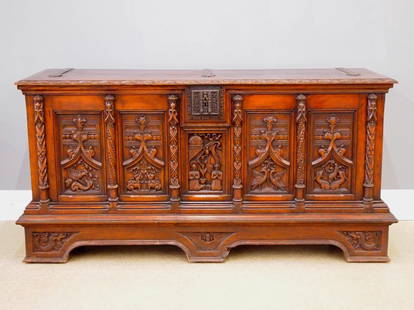 Gothic Revival Armory Chest: A 19th century Gothic Revival Period carved Oak armory chest. Carved lift top over a central figural panel flanked by four carved tracery panels with animal figures and carved pilasters, Iron hinges a