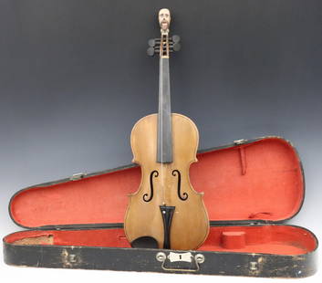 American Folk Art Violin: A late 19th century American Folk Art violin with carved head. Softwood instrument with a carved figural top depicting a man's head with polychrome detail. Instrument with wear and losses. 25 1/2" lon