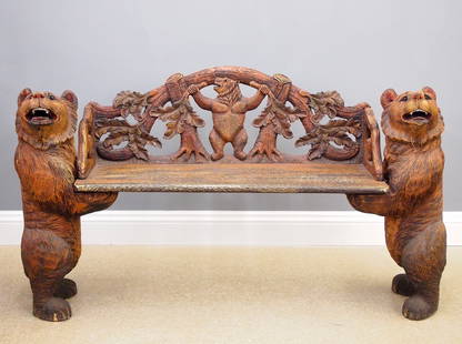 Carved Bear Bench: A late 20th century Black Forest style Bear bench. Carved hardwood with standing Bear ends supporting a bark carved seat and filigree back with Bear and Oak leaf design. Original finish with glass eye