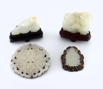 4 pc Chinese White Jade: Four pieces of early 20th century Chinese carved White Jade. Includes two brooches with a pierced Buddha and Medallion designs, and two miniature carved figures depicting smiling Sages and a Bird with