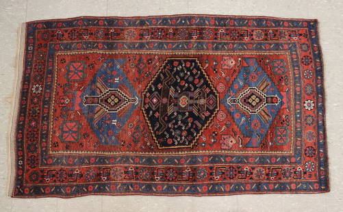 Persian Afshar Rug: A 4.3' x 7.2' Persian Afshar rug. Multi-color geometric design with Blue medallions and tribal figures within multiple borders on a Brick Red field. Some wear and minor fading, some losses to fringe.