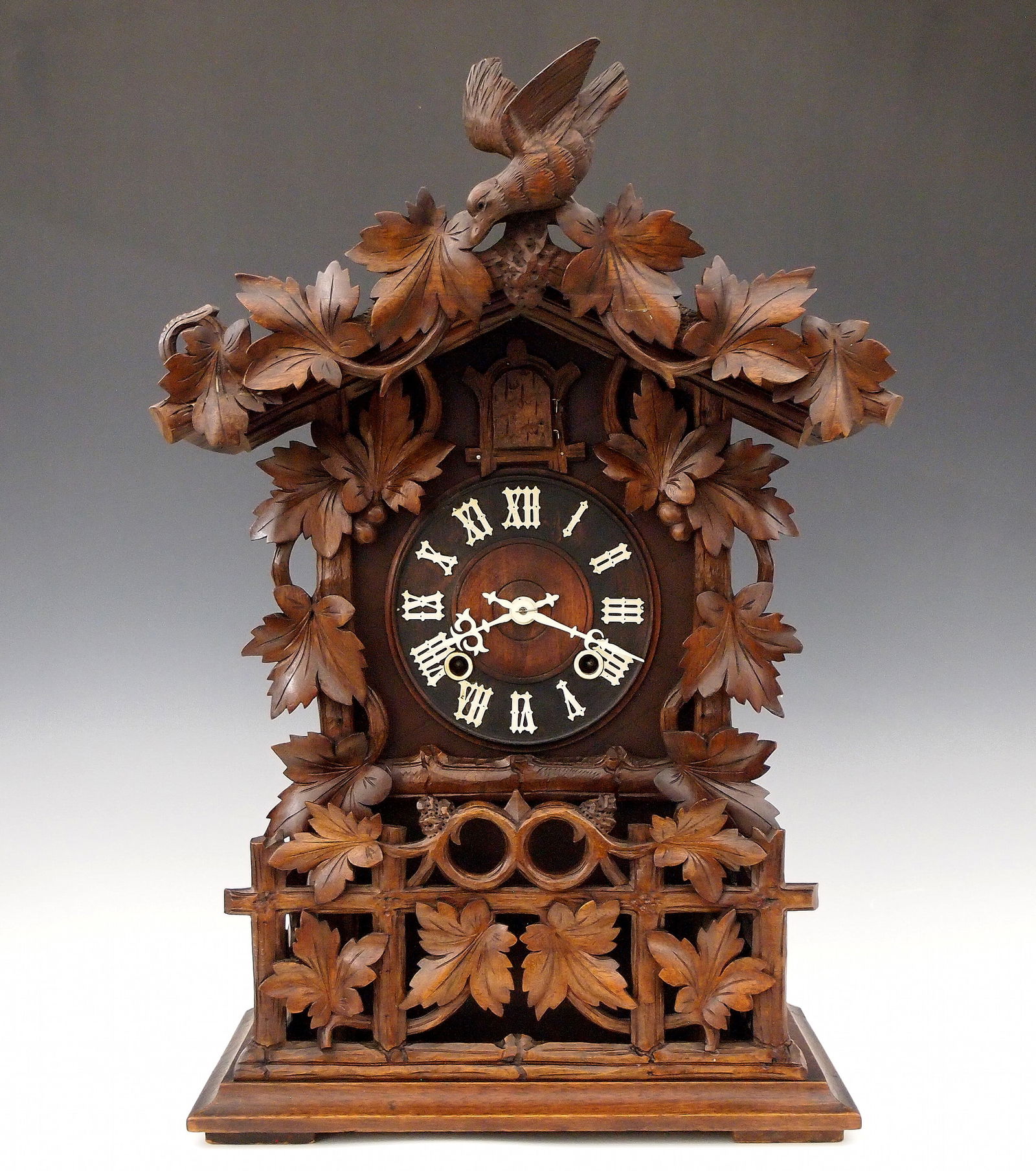 Junghans Black Forest Table Cuckoo Clock: A 19th century Black Forest table Cuckoo clock by Junghans, Schramberg, Germany. 8-day time and strike movement with solid Brass plates and wooden dial with bone hands and applied Roman numerals. Carv