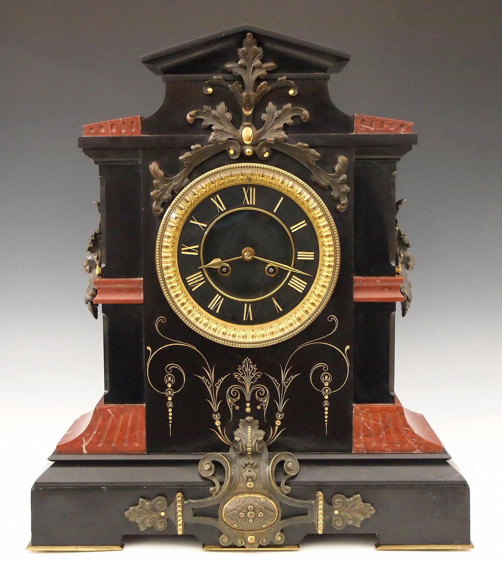 S. Marti French Mantel Clock: A late 19th century French mantel clock by Samuel Marti & Cie, Paris. 8-day time and strike movement with circular Brass plates and Black marble dial with Gold Roman numerals, and cast bezel. Black ma