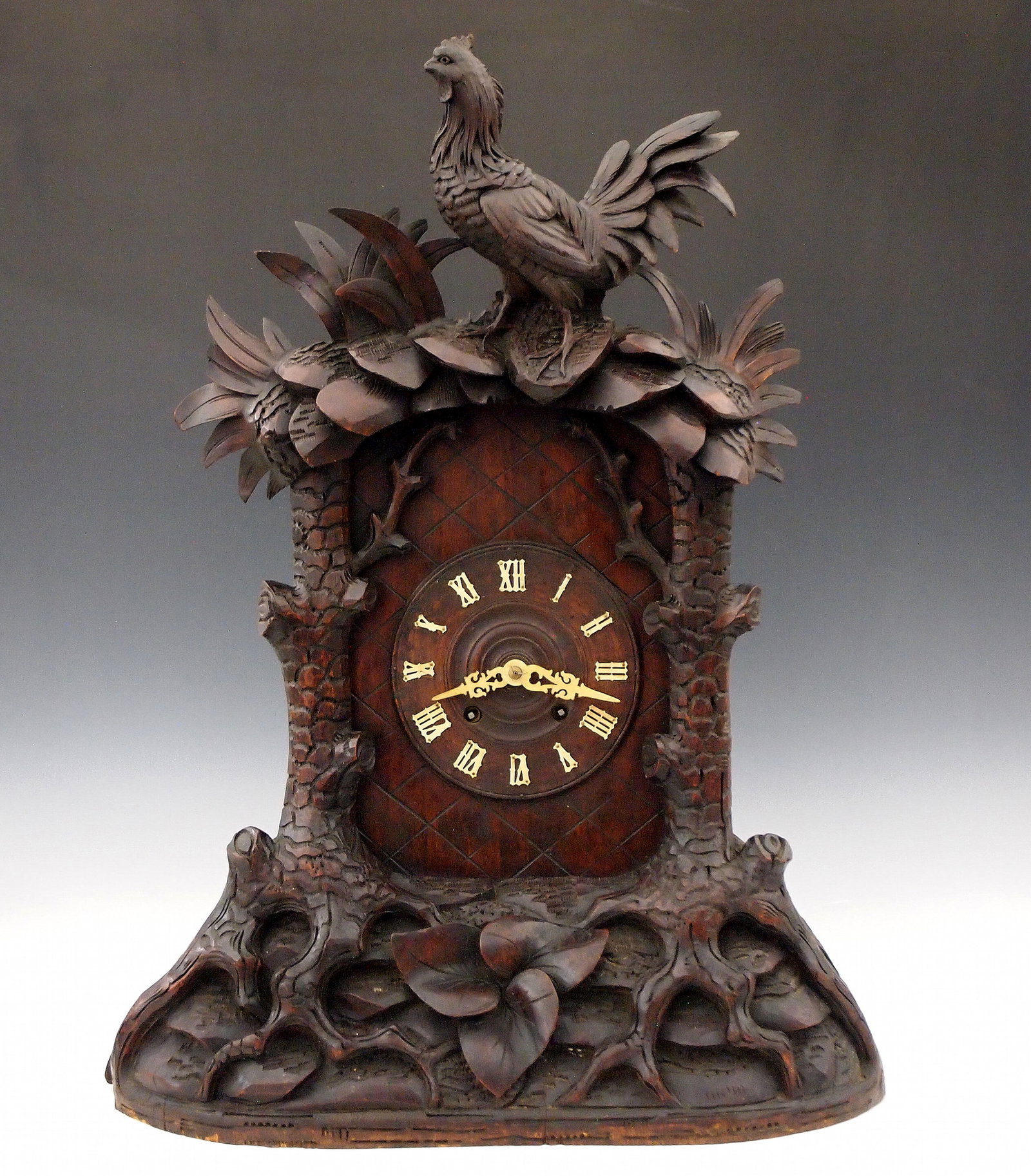Black Forest Table Clock: A 19th century Black Forest table top clock. French 8-day time and strike movement with solid Brass plates, wood dial with bone hands and applied Roman numerals. Walnut case with extensive carved deta