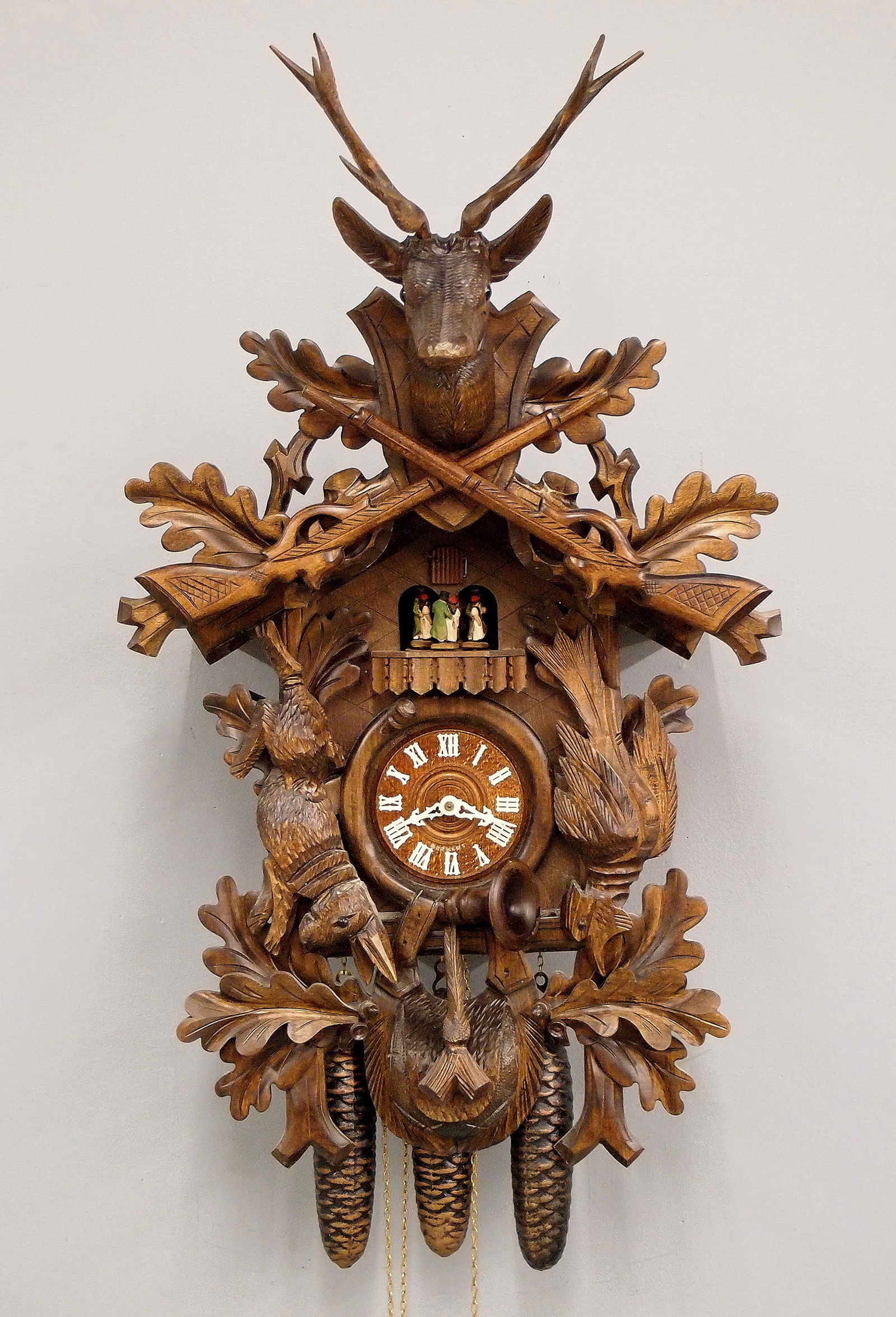 Schneider & Sohne Musical Cuckoo Clock: A late 20th century Black Forest Cuckoo wall clock by Anton Schneider & Sohne. 30-hr three train weight driven time and strike movement with automaton and battery operated music box, wooden dial with