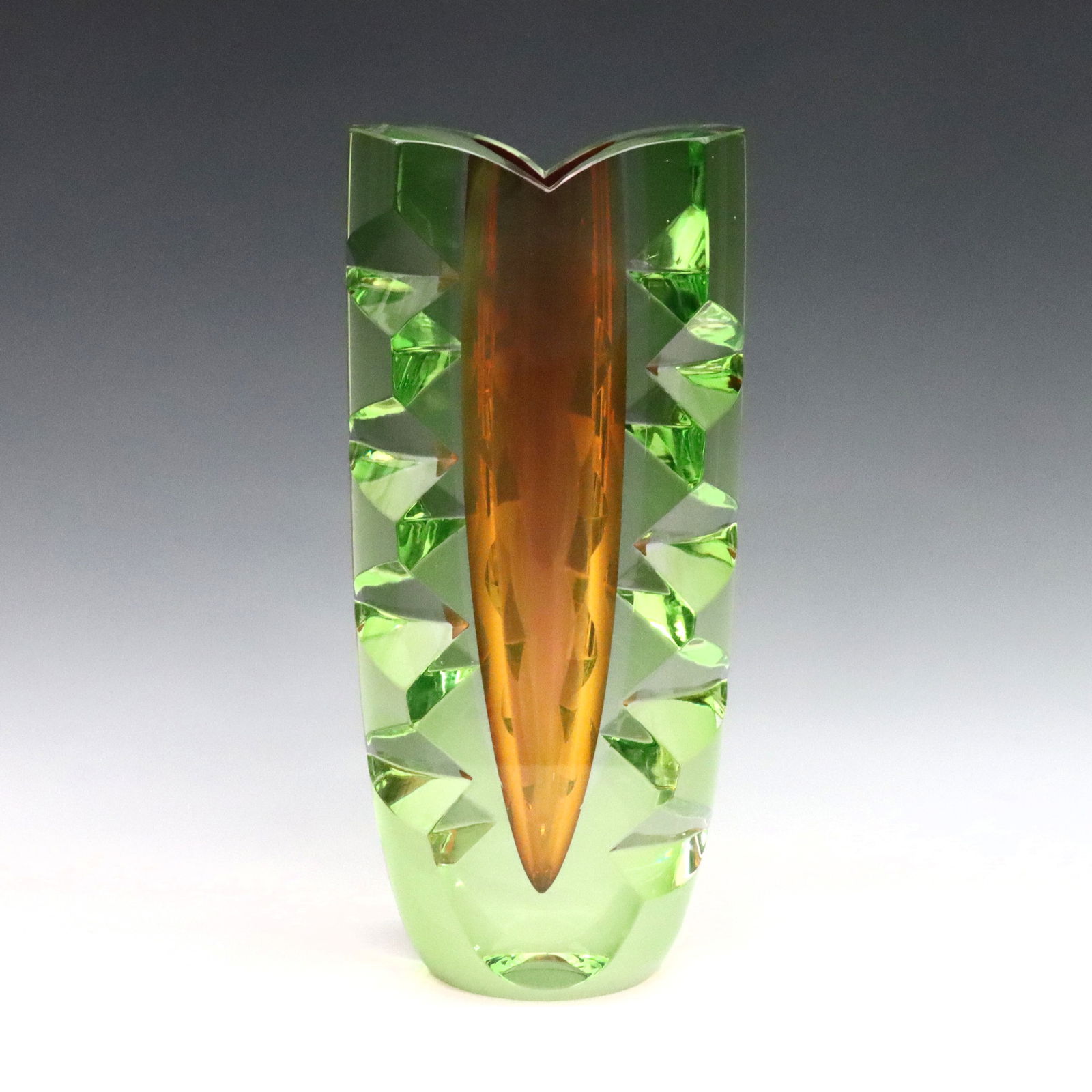 Kosta Boda Warff Art Glass Vase: A late 20th century Goran Warff for Kosta Boda Art Glass vase. Tapered form with Green exterior, prism cut-outs and Cranberry sommerso interior. Signed "Kosta Boda / Goran Warf" and numbered "Lim. Ed.