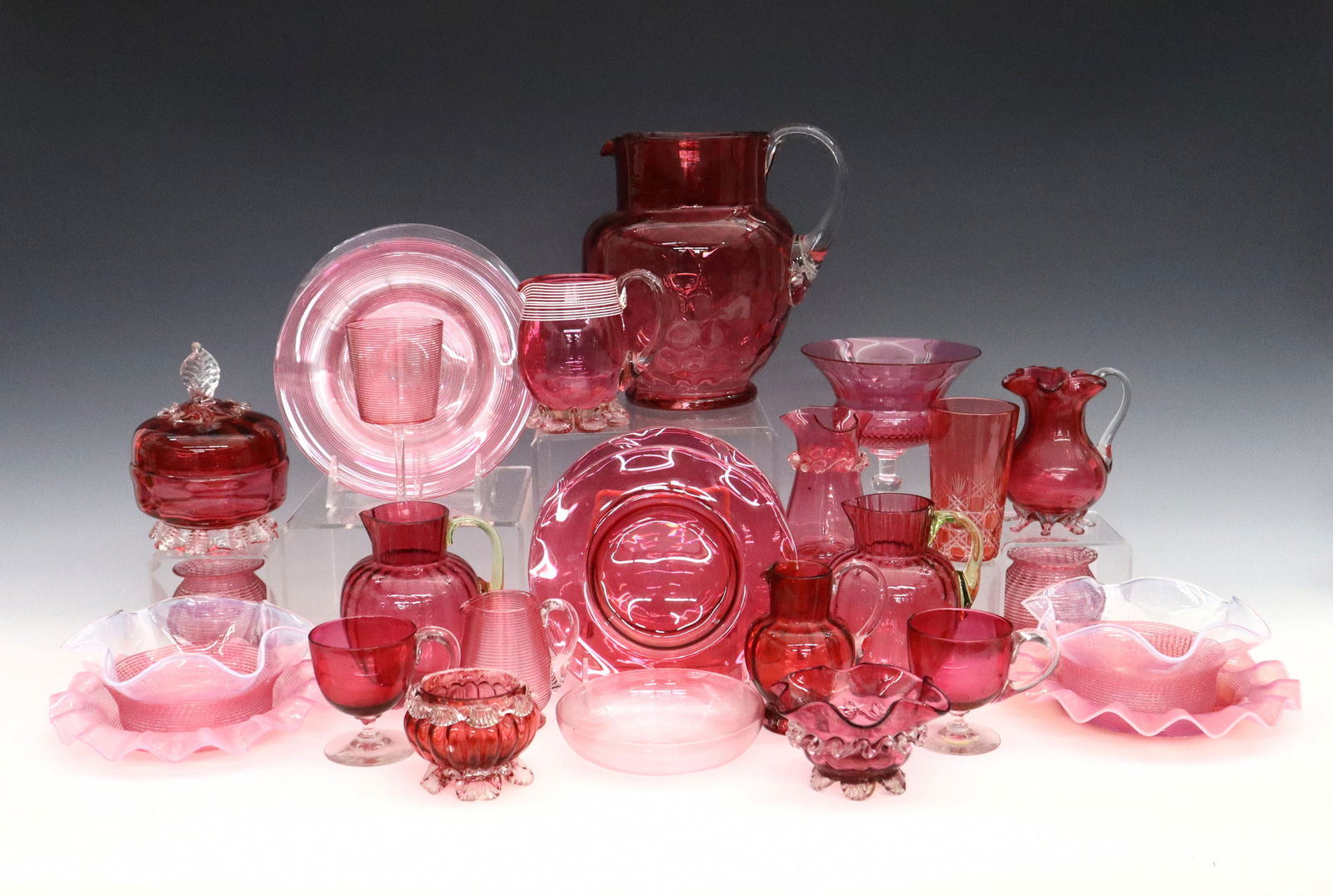 26 pc Victorian Art Glass: Twenty-six pieces of 19th century Victorian Period Art Glass. Cranberry and Opalescent glass bodies, includes pitchers, dishes, bowls, a pair of votives, a covered box, stemmed glass, salt cellar and