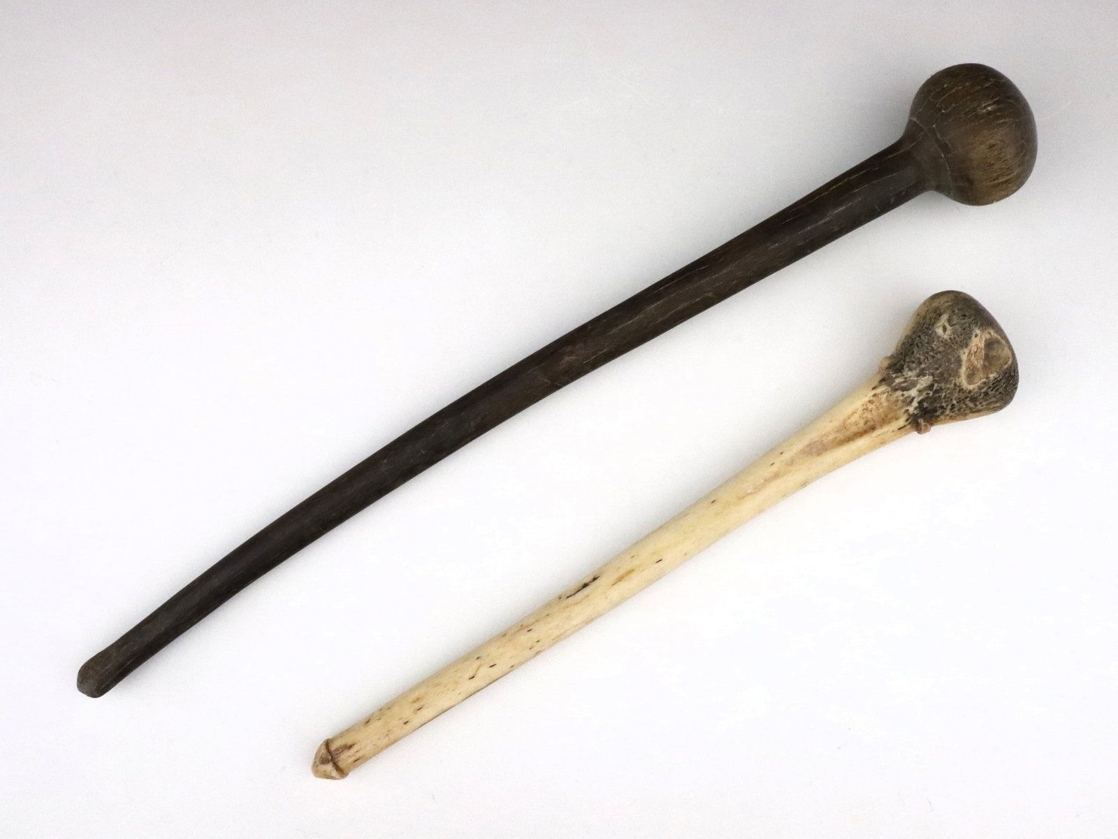 2 African Maasai Rungu Clubs: Two African Maasai culture animal and wooden bone Rungu clubs. Some wear. Up to 17 1/2" high. ESTIMATE $100-150 NOTE: From the collection of Fred Brown, Brighton, Michigan. Purchased in Africa during 