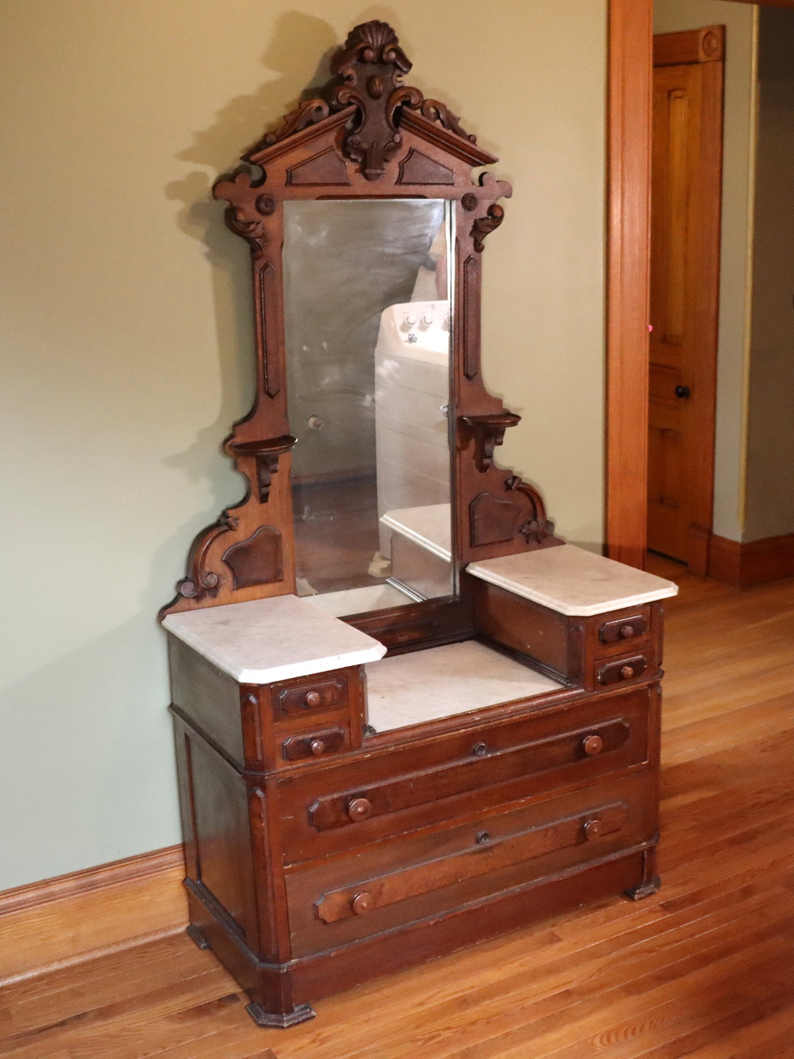 Victorian Dresser: A 19th century Victorian Period dresser. Walnut construction with Burl detail, carved crest over a mirrored back, Marble tops and four short over two long dovetailed drawers on a bracket base. Poorly 