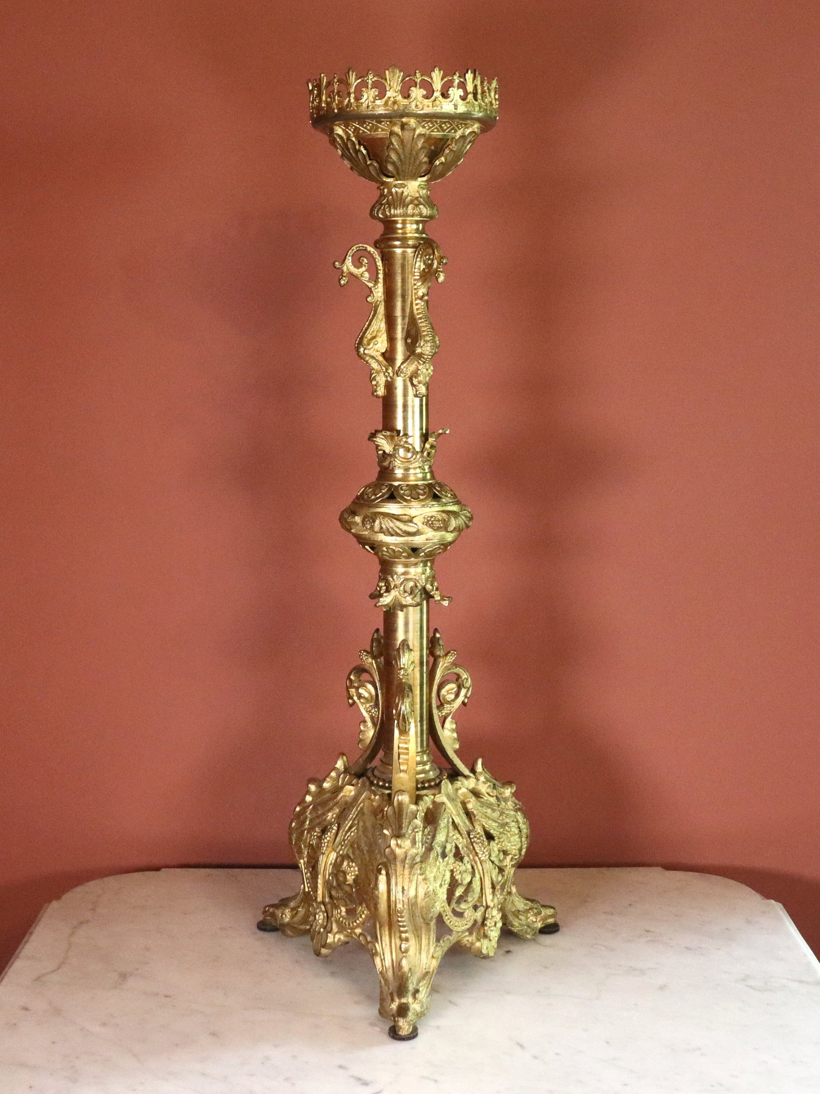 Neoclassical Bronze Altar Stick: A 19th century Neoclassical Bronze altar stick. Pierced top on a columnar stem with applied Dragons and acanthus leaf details on a pierced base with Phoenix form feet. Wear to original Gilded finish, 