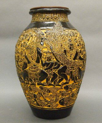 Cambodian vase: A mid 20th century Cambodian earthenware vase. Two tone figural design with men pulling a Giant Squid from the sea. Minor wear. 18 1/2" high. ESTIMATE $200-400
