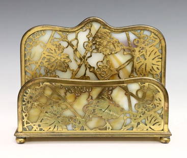 Tiffany Grapevine Letter Rack: An early 20th century Tiffany "Grapevine" pattern letter rack. Gilded Bronze frame with pierced foliate design and White/Carmel slag glass panels. Marked "Tiffany Studios / New York" and "1019".