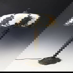 Bradley Hubbard Table Lamp: An early 20th century Bradley Hubbard Art Nouveau style table lamp. Cast filigree shade with framed White/Carmel Slag bent glass panels on a cast base with three light design and circular foot.