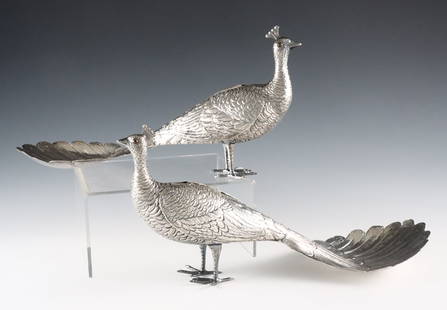 Pr Sterling Peacock Dishes: A pair of early 20th century American Sterling Silver Peacock form dishes. Peacock figures with glass eyes, articulated wings and tail feathers that form a dish. Impressed "Sterling" at underside