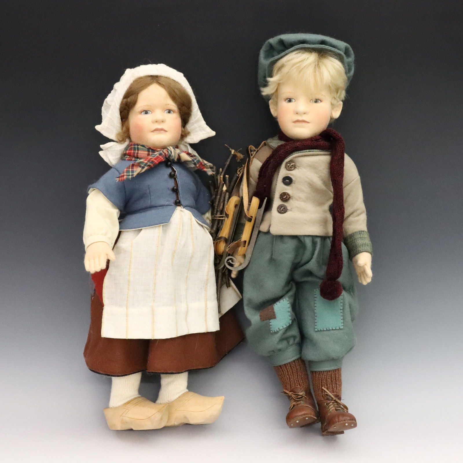 Pr John Wright Felted Dolls: A pair of late 20th century R. John Wright "Hans Brinker" dolls. Stuffed felt swivel heads with molded features and painted detail on jointed felt bodies. Depict "Hans" and "Greta Brinker" from Wright