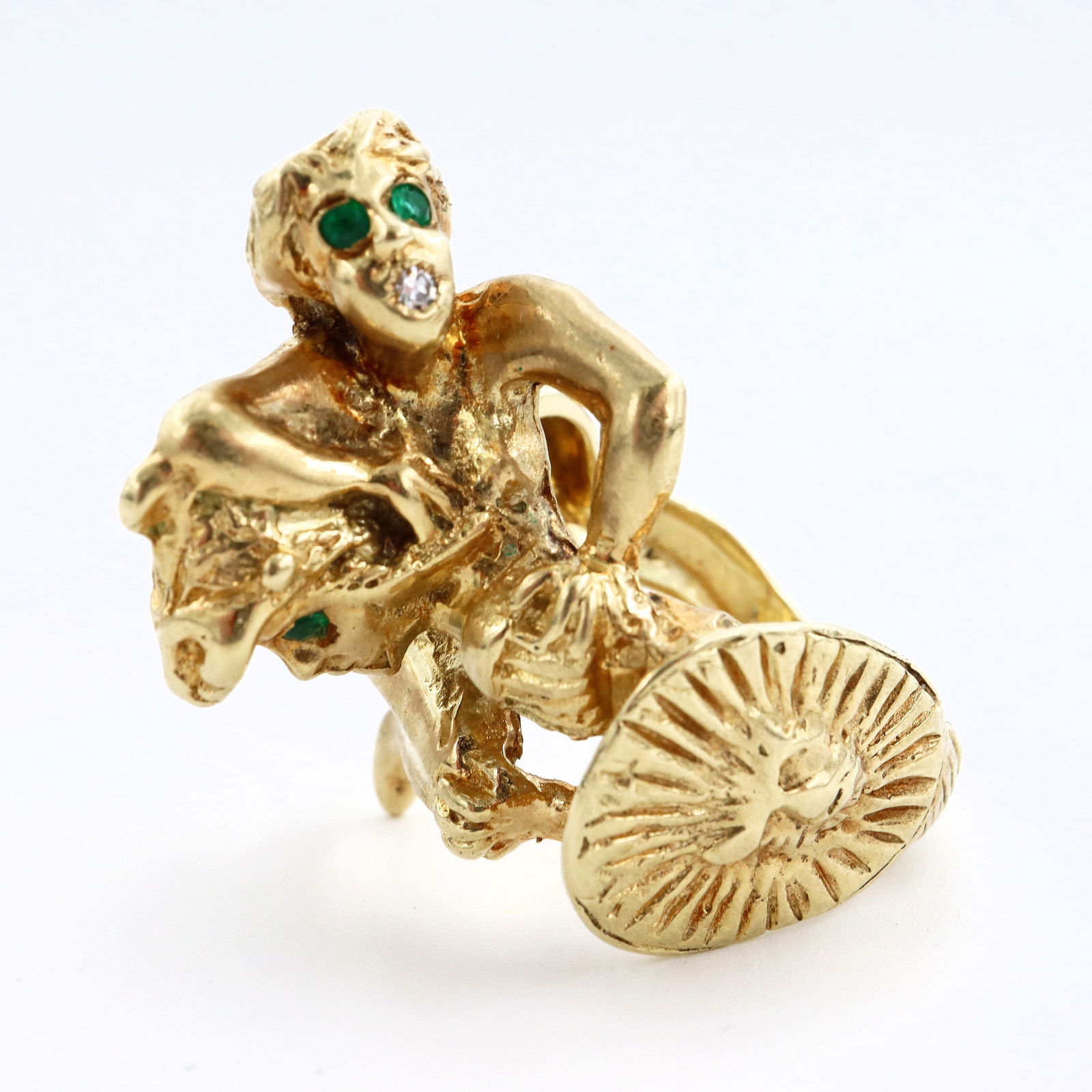 14k Gold Figural Gladiator Ring: A vintage gent's 14k Gold figural Roman Gladiator ring. Features a nude female figure wrestling a Gladiator with Lion mask helmet and shield, with Emerald and Diamond accents. Marked "14k" and "Spiros