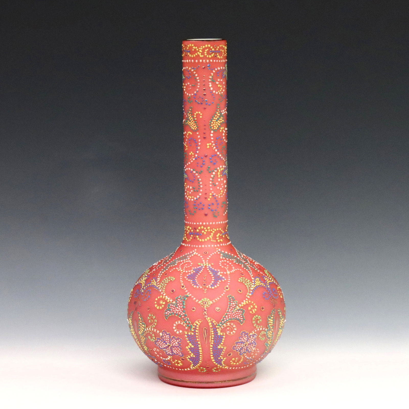 Art Glass Vase: A turn of the century Art Glass vase in the manner of Thomas Webb. Bottle form cased glass bottle with Pink satin exterior and enameled multi-color "tapestry" decoration. Minor wear to enamel. 10 1/4"