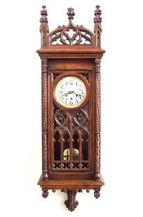 Gustav Becker Gothic Wall Clock: A turn of the century Gustav Becker Gothic Revival Period wall clock. 8-day spring driven movement with quarter hour Westminster chime, Silvered dial with Arabic numerals and molded Brass bezel, seria