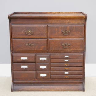 Gunn Stacking File Cabinet: An early 20th century American stacking file cabinet by Gunn Furniture Co., Grand Rapids, MI. Oak construction featuring a molded top over four short drawers and various card and flat file drawers, tw