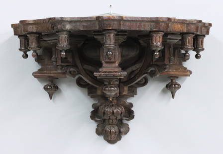 Victorian Oak Wall Shelf: A 19th century Victorian Period wall shelf. Carved Oak construction with a shaped, molded shelf and drop finials on scrolled supports with carved Oak Leaf and Acorn drop. Older dark finish with some w