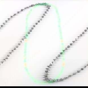 Jade & 14k Gold Necklace: A Jade and 14k Gold necklace. Features sixty-eight Jade beads approx. 7.75 mm each, hand-knotted with twelve graduated 14k Gold spacer beads. Gold unmarked, tested 14k. 76.1 grams total. Minor wear, G