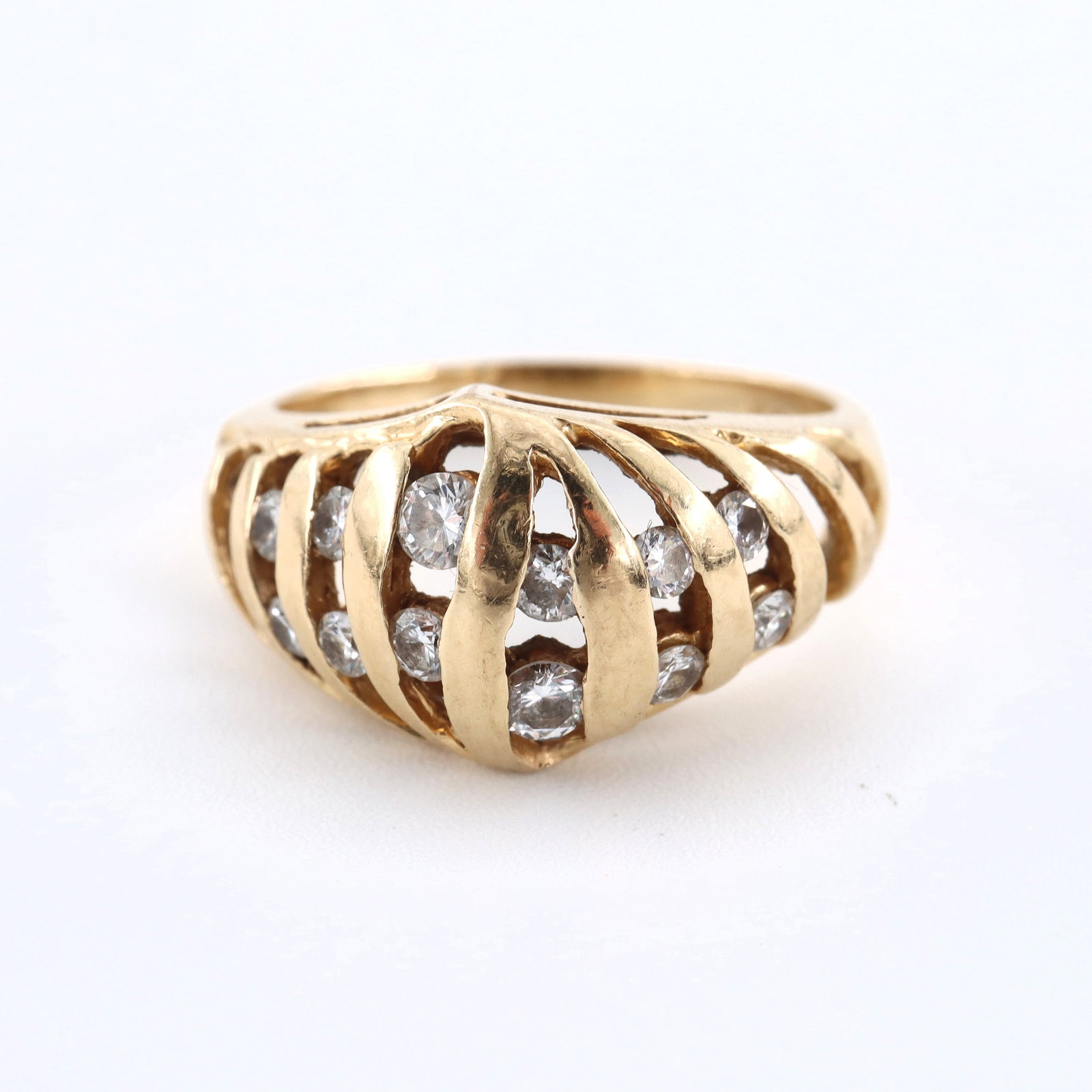 Orange Blossom 14k Gold & Diamond Ring: A vintage Traub Orange Blossom 14k Gold and Diamond ring. Features a domed setting with openwork design and twelve round cut channel set Diamond accents. Marked "Orange Blossom" and "14k". 3.9 troy oz