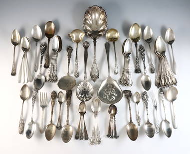 58 pc Sterling Flatware: Fifty-eight pieces of Sterling Silver flatware. Includes souvenir spoons, serving utensils and others spoons by various makers. Each marked "Sterling". 35.00 troy ozs total. Some wear, many monogramme